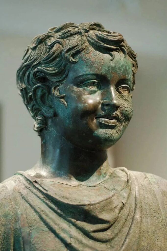 Roman bronze statue of smiling boy | From the blog of Nicholas C. Rossis, author of science fiction, the Pearseus epic fantasy series and children's books
